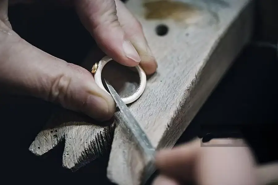 Jewelry artisan shaping a piece by hand