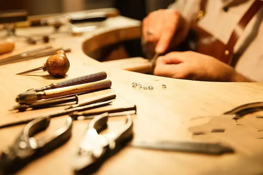 Jewelry artisan working at a traditional jeweler's bench